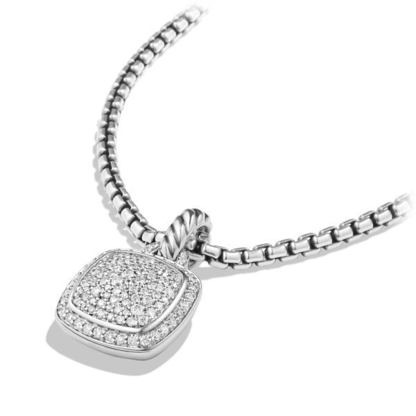 A silver necklace features a box chain and a square-shaped pendant. The pendant is embellished with numerous small, sparkling diamonds and has a rope-like detail connecting it to the chain. The jewelry is displayed on a white background.