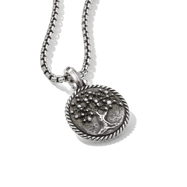 A silver pendant necklace featuring a round medallion with an embossed tree design. The pendant is framed by a braided border and hangs from a box chain. The background is plain white.