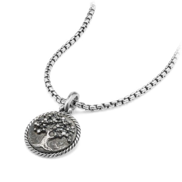 A silver necklace featuring a round pendant with a tree design. The pendant has a twisted rope-like border, and the tree is detailed with small, textured branches and leaves. The chain is composed of rectangular links, adding a subtle, elegant touch.