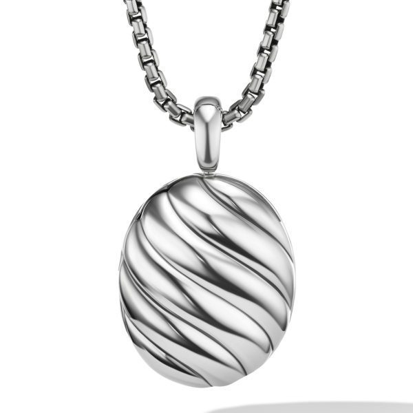 A silver pendant with a swirling design hangs from a sleek, silver chain. The pendant has an oval shape and a polished, reflective surface, giving it a modern and elegant appearance.