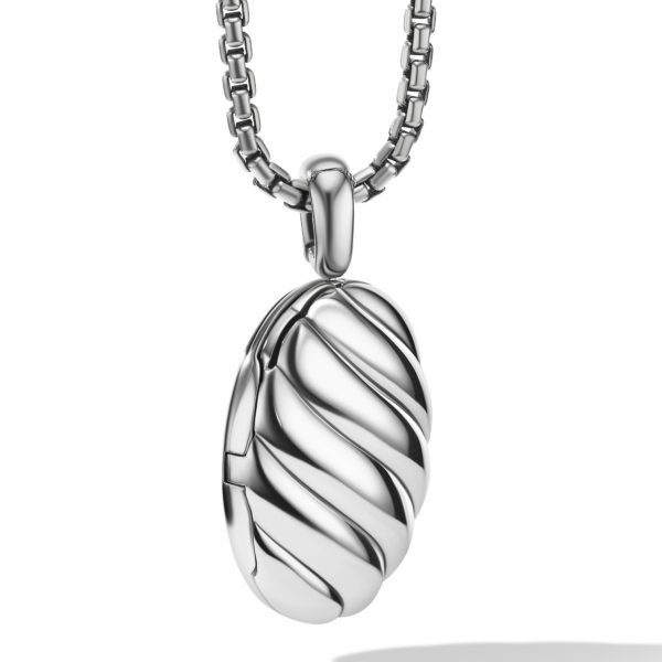 A silver locket pendant with a twisted, wave-like design hangs from a metallic chain. The locket has an elegant and sleek appearance, with smooth, reflective surfaces and a sturdy clasp connecting it to the chain.