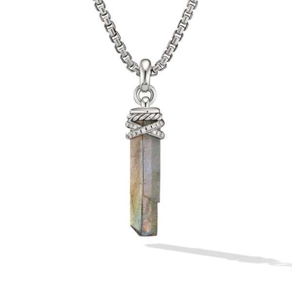 A silver chain necklace with a pendant featuring an elongated, faceted iridescent crystal. The top of the crystal is adorned with decorative silver bands and small embedded diamonds. The necklace casts a subtle shadow against a white background.