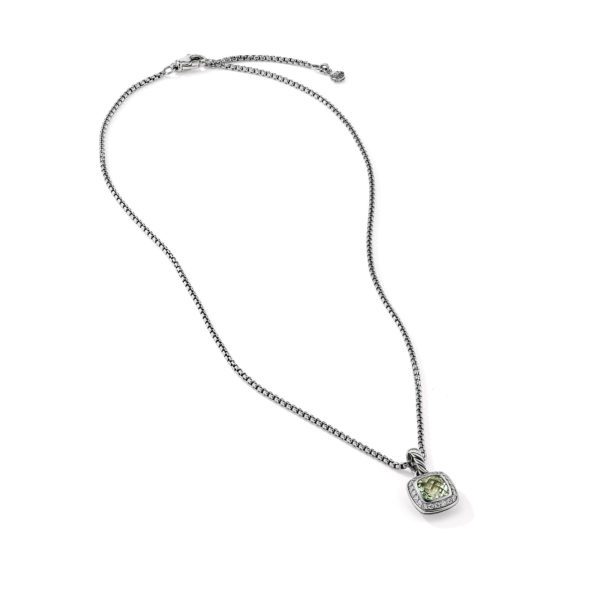 A silver necklace featuring a delicate chain and a pendant with a light green gemstone in a square-shaped setting. The chain has an adjustable clasp closure. The background is white, highlighting the simplicity and elegance of the jewelry piece.