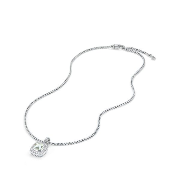 A silver chain necklace with a square-shaped pendant featuring a central white gemstone surrounded by smaller stones, lying on a white background. The necklace has a lobster clasp.