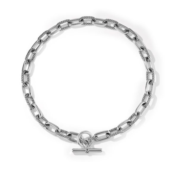 A silver chain necklace with oval links, featuring a toggle clasp. The links have a twisted rope texture, giving the necklace a sophisticated and polished look.