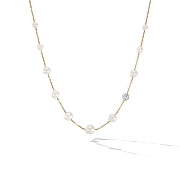 A delicate gold chain necklace adorned with evenly spaced white pearls and a single round diamond cluster. The necklace is displayed against a white background with a softly cast shadow beneath.