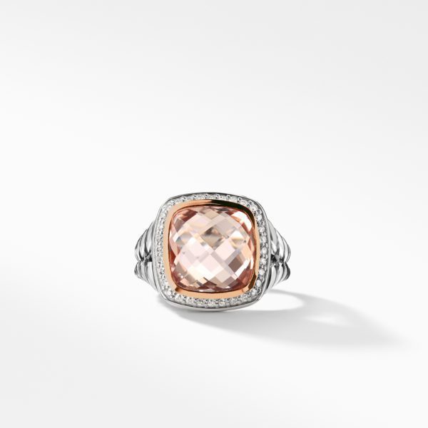 A silver ring featuring a large, rectangular-cut peach gemstone with a faceted surface. The stone is surrounded by a border of small diamonds and the band has a textured, ridged design. The ring is displayed on a clean white surface with soft lighting.