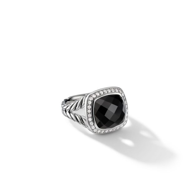 A sterling silver ring features a large, square-cut black gemstone in the center, surrounded by a border of small, sparkling white diamonds. The band has a twisted rope design. The ring casts a shadow on the white background.