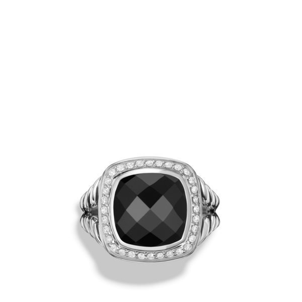 A silver ring featuring a large, square-cut black gemstone at its center, surrounded by small diamonds and a textured band. The ring has a polished, elegant design against a white background.