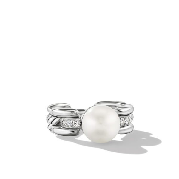 A silver ring featuring a central round white pearl, flanked by small diamonds set into the band, which is designed with a chain-link pattern. The ring casts a slight shadow on a plain white background.