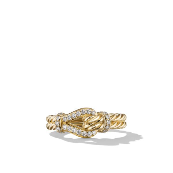 A gold ring featuring a twisted design and an intricate knot adorned with small sparkling diamonds, set against a plain white background.