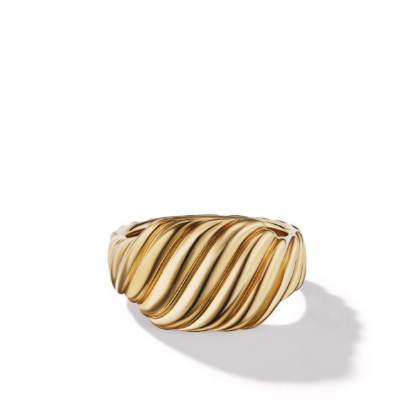 A gold ring with a textured, twisted design is displayed on a white background. The ring casts a subtle shadow on the surface below.