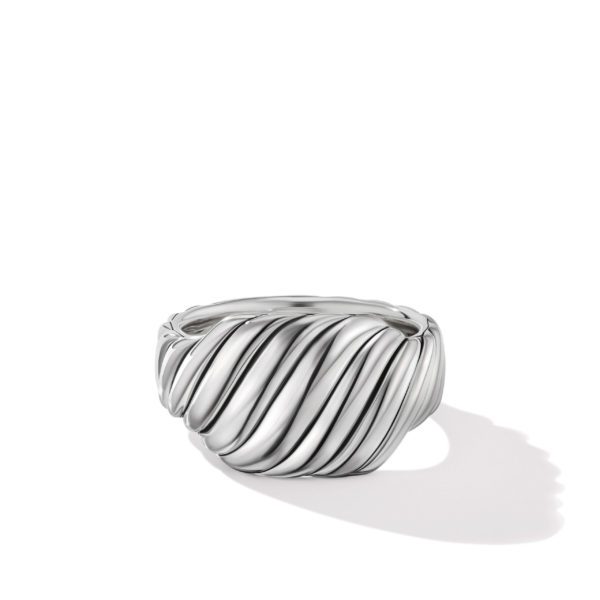 A close-up image of a silver ring featuring a bold, twisted design with diagonal grooves. The ring's polished surface reflects light, and its shadow is cast on the white background.