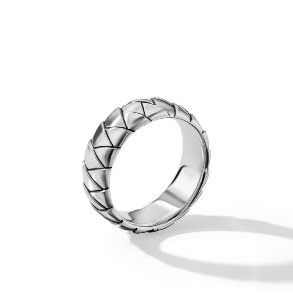 A silver ring with a geometric, braided pattern on the band. The ring casts a soft shadow against a plain white background.