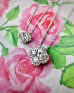 The dazzle is in the detail of these clover-shaped diamond halo pendants.