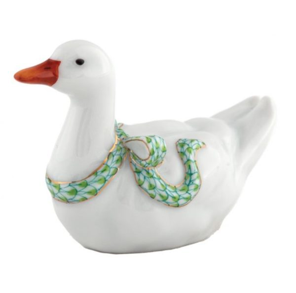 Introducing the Herend Sitting Duck Figurine - Keylime: This elegant porcelain duck features a white body accented with an orange beak. Its neck is beautifully adorned with a decorative green and gold garland, adding a festive touch to its refined appearance. The figurine boasts a smooth, glossy finish for a sophisticated look.