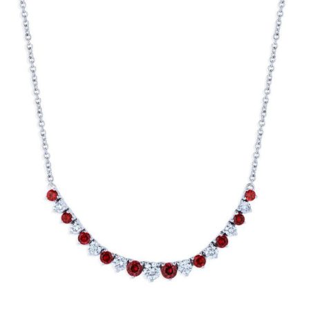 A silver necklace with an alternating pattern of small round ruby and white gemstones, arranged in a decorative line along the lower part of the chain.