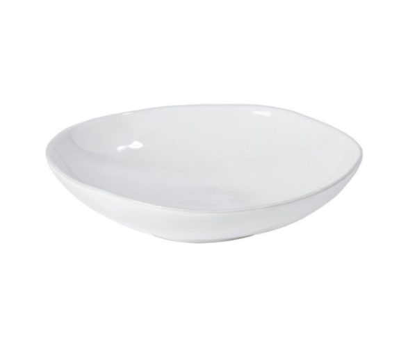 The Costa Nova Livia Pasta Bowl - White, a plain white, slightly shallow ceramic bowl with a glossy finish, is viewed from a side angle against a white background. The bowl features a subtle ripple at the edge, giving it an organic and hand-crafted appearance.