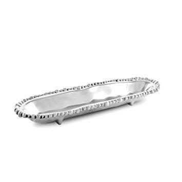 The ORGAN PEARL CRACKER TRAY is a long, oval-shaped, silver tray featuring a textured, beaded edge. It boasts a smooth, reflective surface and rests on four small feet that slightly elevate it from the underlying surface. Its design is elegant and minimalist.