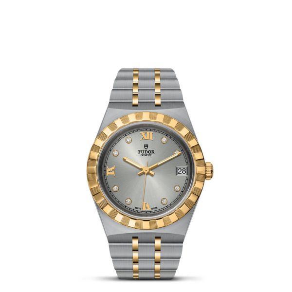 The TUDOR Royal wristwatch features a two-tone design with a grey dial and a dual gold-and-silver metal band. The time is displayed using gold Roman numerals for 6, 9, and 12, alongside diamond hour markers. Additionally, the date is conveniently shown in a white square at the 3 o'clock position.