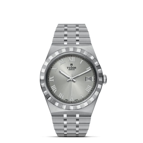 The TUDOR Royal wristwatch features a stainless steel band and case with a fluted bezel. It showcases a silver dial adorned with Roman numeral hour markers, a date window at the 3 o’clock position, and three hands. The TUDOR logo and "Geneve" are prominently displayed under the 12 o'clock marker.