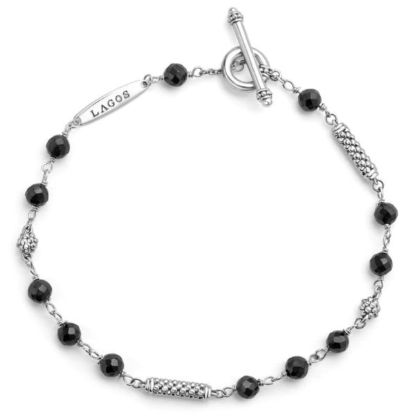 The LAGOS Caviar Icon Black Ceramic Beaded Bracelet showcases a delicate design with alternating black ceramic beads and textured silver metal segments. It includes a small, engraved tag bearing the word "LAGOS," and is secured with a toggle clasp.