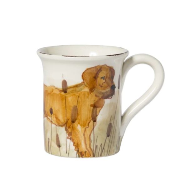 The Vietri Wildlife Mug - Hunting Dog showcases a beautifully painted image of a golden-brown dog standing amongst tall grass and cattails, set against a white background with a handle on the right side.