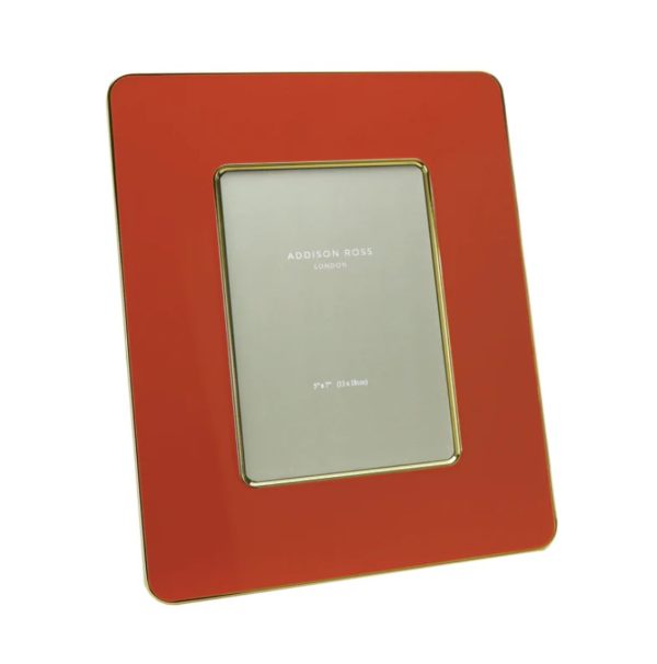 This is an image of an Addison Ross 5x7" Orange and Gold Enamel Frame. The frame has a rectangular shape with a glossy orange finish and gold trim around the edges. It is designed to hold a 5x7 inch (13x18 cm) photograph.