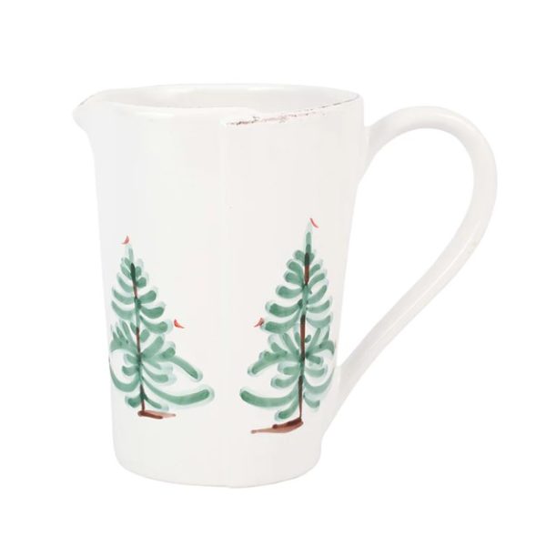 The Vietri Lastra Holiday Pitcher is a white ceramic pitcher with a handle, adorned with two stylized green Christmas trees and small red birds perched on the branches.