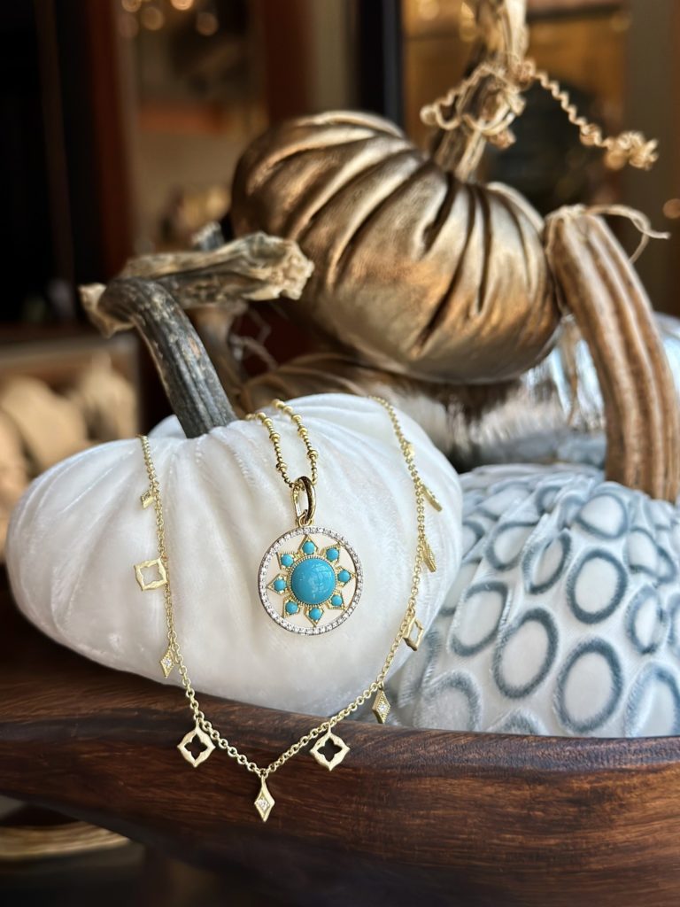 Jude Frances Moroccan collection necklaces draped over a white pumpkin in a fall scene