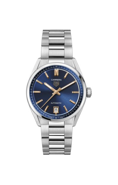 The TAG Heuer Carrera Date is a silver wristwatch featuring a blue dial with gold accents, a date display at the 6 o'clock position, and "CARRERA" and "TAG Heuer" logos. It comes with a stainless steel bracelet and boasts automatic movement against a plain white background.