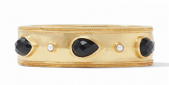 The Julie Vos Cannes Stone Statement Hinge Bangle in Obsidian Black is a gold bracelet adorned with three large black gemstones and two small white pearls, evenly spaced around its circumference. The bracelet features a detailed, textured design along its edges and a smooth finish on its central band.