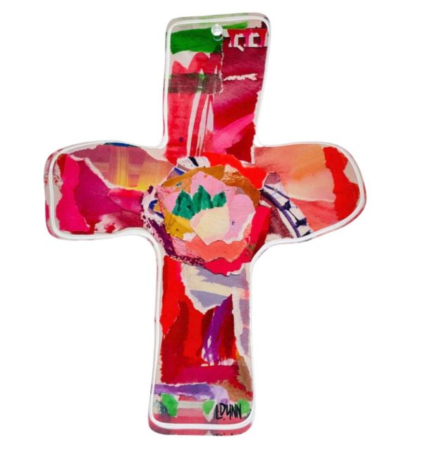 The Lauren Dunn Everlasting Love Acrylic Cross - Red is a vibrant cross-shaped artwork featuring abstract patterns and bold colors, including red, pink, green, and blue. The central design resembles a colorful floral arrangement, with the artist's signature "Dunn" at the bottom.