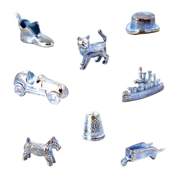 An assortment of classic Birmingham Edition Monopoly Board Game pieces arranged in a circular pattern. The pieces include a shoe, cat, top hat, car, ship, Scottie dog, thimble, and wheelbarrow. Each piece is metallic and intricately detailed, set against a white background.