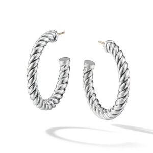 A pair of silver sculpted hoop earrings from David Yurman float elegantly with a white background.