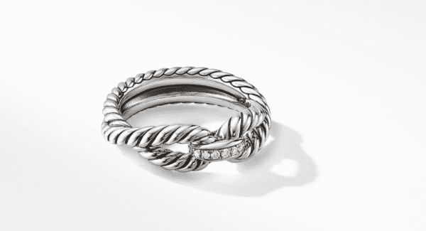 Introducing the 8MM CABLE LOOP RING: A stunning silver ring featuring a twisted rope design with an overlapping section adorned with small, sparkling diamonds. Elegantly displayed against a clean, white background, this exquisite piece casts a subtle shadow for added sophistication.