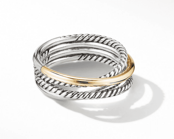 Introducing the SMALL CROSSOVER RING, a stunning piece featuring multiple intertwined bands in silver and gold. The silver sections boast an intricate twisted rope-like design, while a sleek gold band wraps partially around them. This exquisite ring casts a subtle shadow on a plain white background.