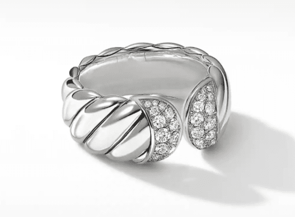 A close-up image of the SCULPTED CABLE RING showcasing its distinctive twisted rope-like design, adorned with small, sparkling diamonds on one part of the twist.