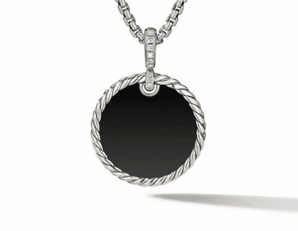 A 24MM Reversible Elements Enhancer pendant on a silver chain necklace. The round pendant features a black center framed by a twisted silver rope design. The chain is made up of small, interlocking links and the top of the pendant is encrusted with small, sparkling stones.