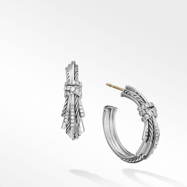 Introducing the ANGELIKA HOOPS – a pair of luxurious silver hoop earrings with an intricately twisted design. Each earring features a cluster of small, sparkling diamonds wrapping around the top. One earring is shown with its post visible, while the other is fully closed, both displayed on a white background.