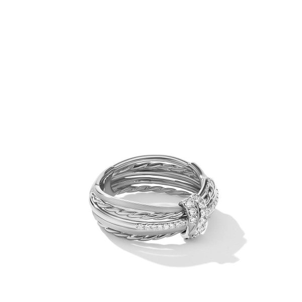 The ANGELIKA LINEAR RING is a silver piece showcasing intricate detailing with multiple bands and a central row of diamonds. The design features both twisted and smooth segments, creating a unique, elegant look. The ring casts a soft shadow against a plain white background.