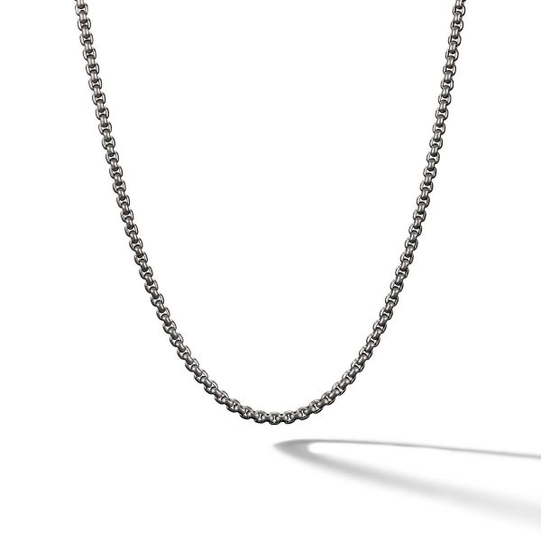 A close-up of the 2.7MM MENS BOX CHAIN. The chain showcases tightly linked circular segments and casts a soft shadow on a white background, displaying its minimalist and elegant design.