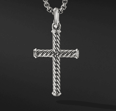 The 35MM CABLE CROSS features a stunning textured, twisted rope design and hangs elegantly from a chain. The pendant is set against a solid black background, accentuating its intricate details.