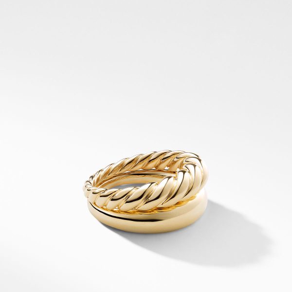 A close-up image showcasing the PURE FORM S/2 STACK RINGS placed on a white surface. The ring on top features a twisted rope design, while the one underneath is a smooth, plain band. Both rings boast a polished, shiny finish.