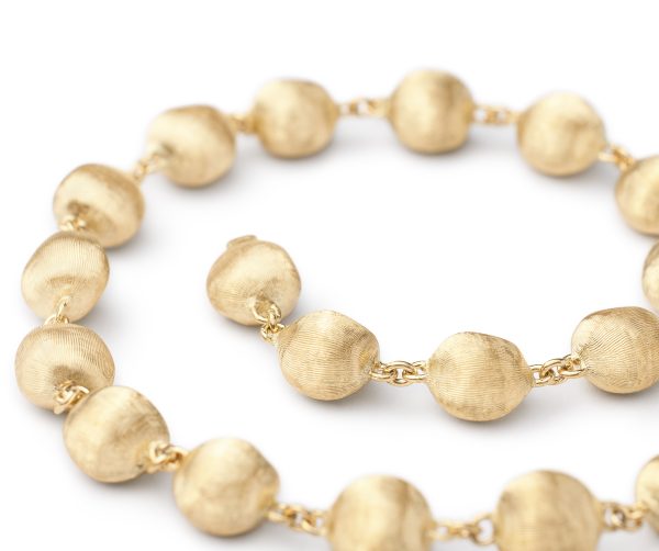 A close-up of the Marco Bicego Africa Bead Bracelet showcasing textured spherical beads with a matte finish, connected by small links and arranged in a circular pattern on a white background.