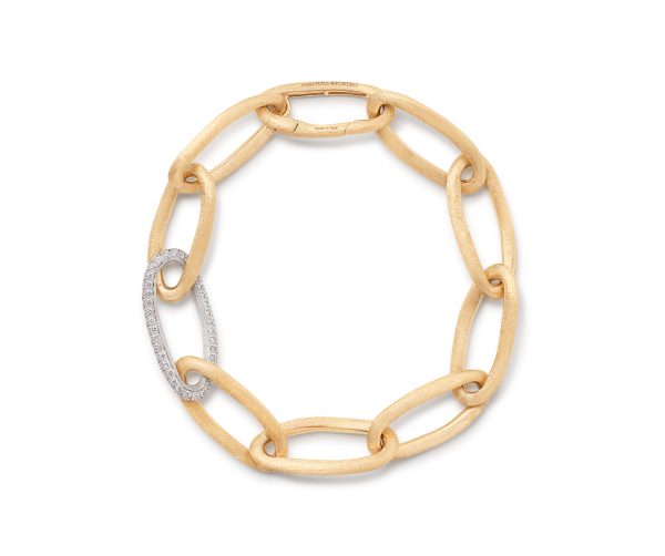 The Marco Bicego Jaipur Oval Link and Diamond Bracelet is a stunning gold chain bracelet with large oval links. One of the links is adorned with small, sparkling diamonds, providing an elegant contrast to the design. The overall look is simple yet sophisticated.