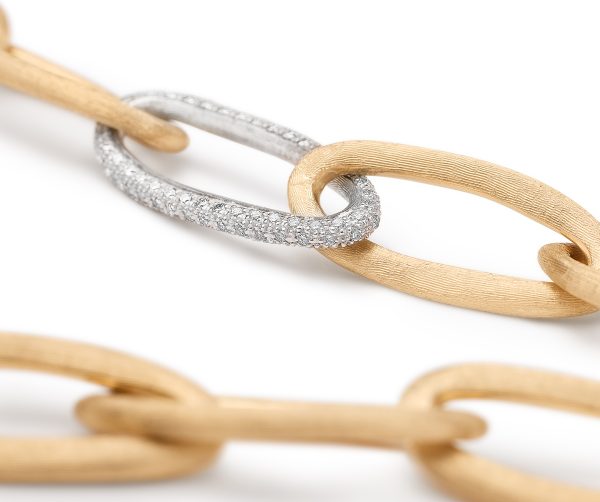 Close-up of the Marco Bicego Jaipur Oval Link and Diamond Bracelet, showcasing interlocking oval links with two textured gold links and a silver link embellished with small diamonds, set against a white background.