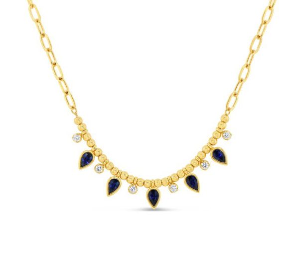 The Bromberg's Signature Collection Sapphire and Diamond Necklace showcases a gold chain-link design adorned with gold beads and alternating teardrop-shaped blue sapphires and round clear diamonds hanging from it. The gems are arranged in a symmetrical pattern, creating an elegant and ornate look against a white background.