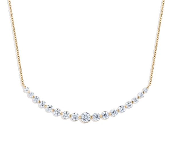 The Bromberg's Signature Collection Diamond Curve Necklace features a series of round, sparkling gemstones that are delicately spaced along the lower portion of a thin and refined chain. The gemstones progressively decrease in size from the center outwards, creating a graceful and elegant look.