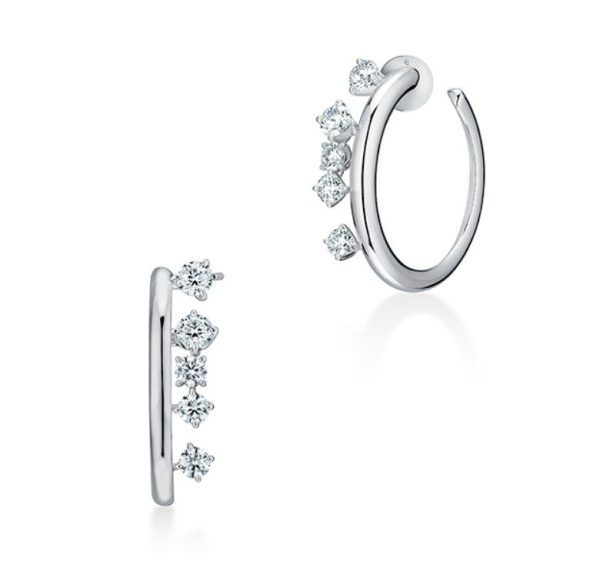 Introducing the Hearts on Fire Barre Floating Diamond Small Hoops: These elegant silver hoop earrings feature five small round diamonds each, set in a linear arrangement along the outer edge. One earring is displayed from the front and the other from the side, showcasing their polished and sophisticated design.